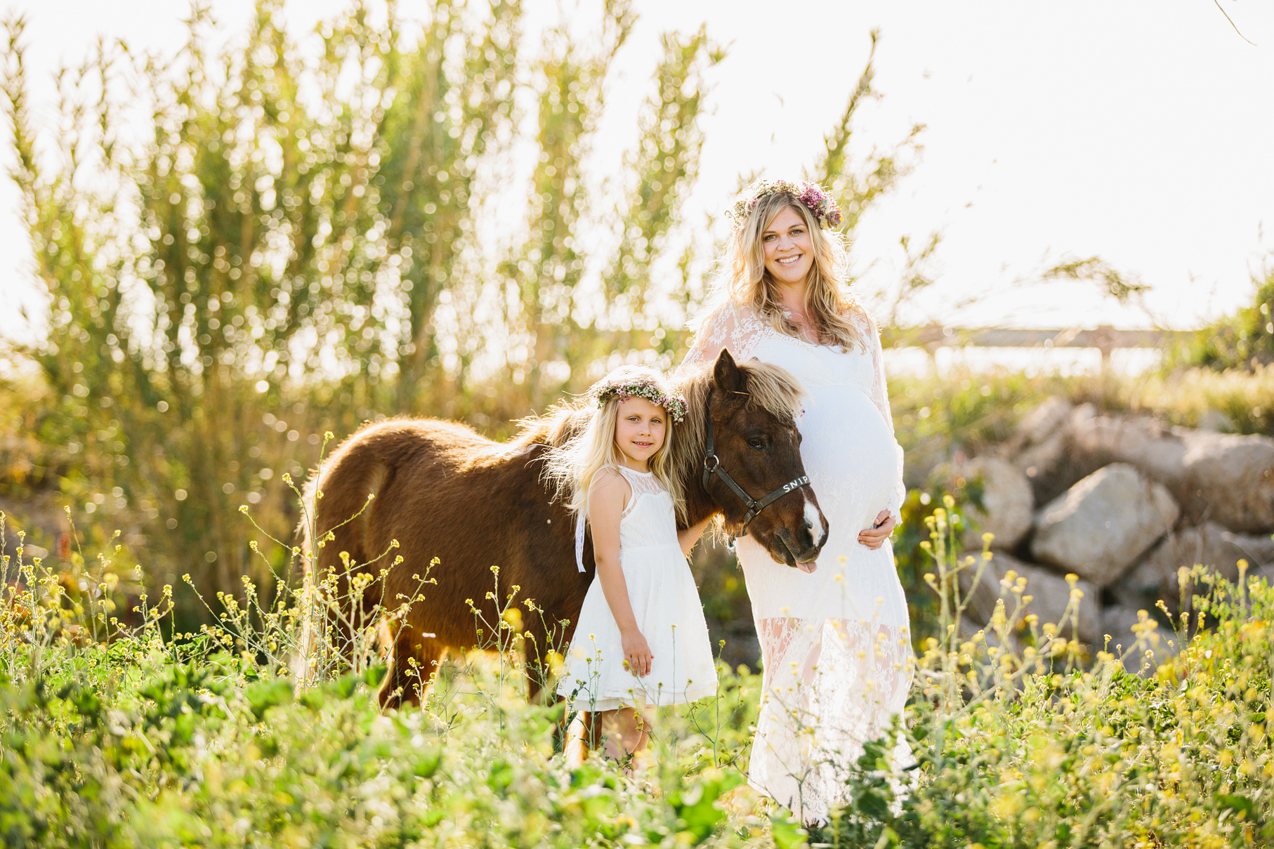 A maternity photography session in california with mother daughter their horse and a creek