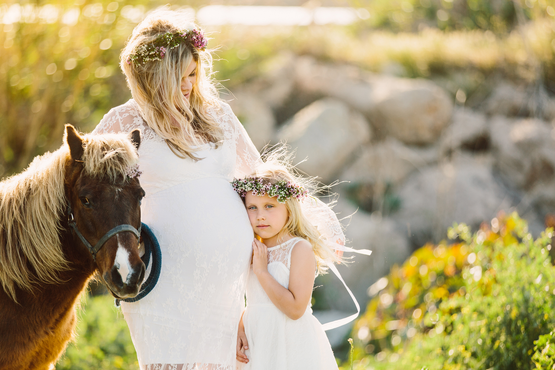 A maternity photography session in california with mother daughter their horse and a creek