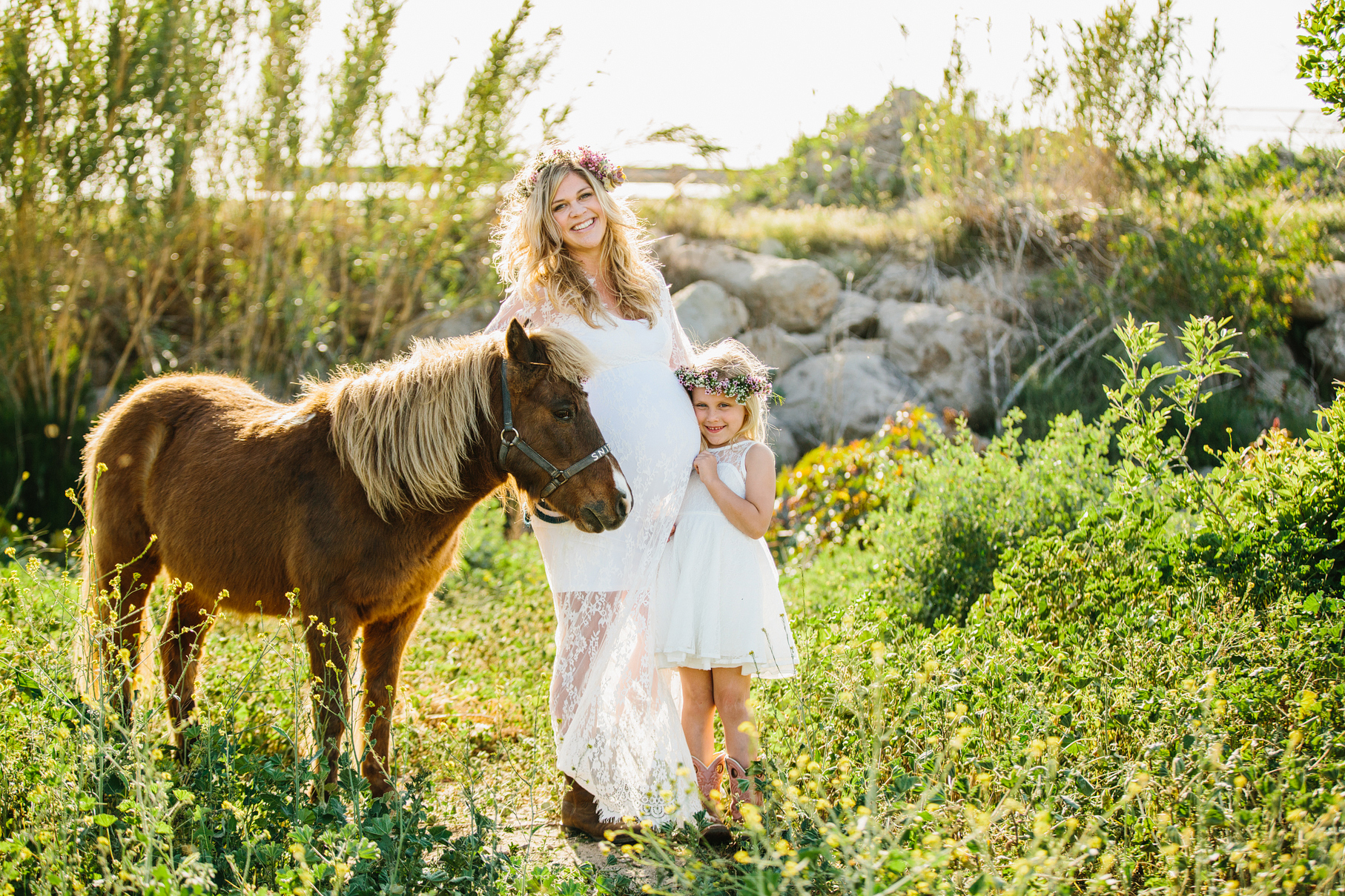 A maternity photography session in california with mother daughter their horse and a creek