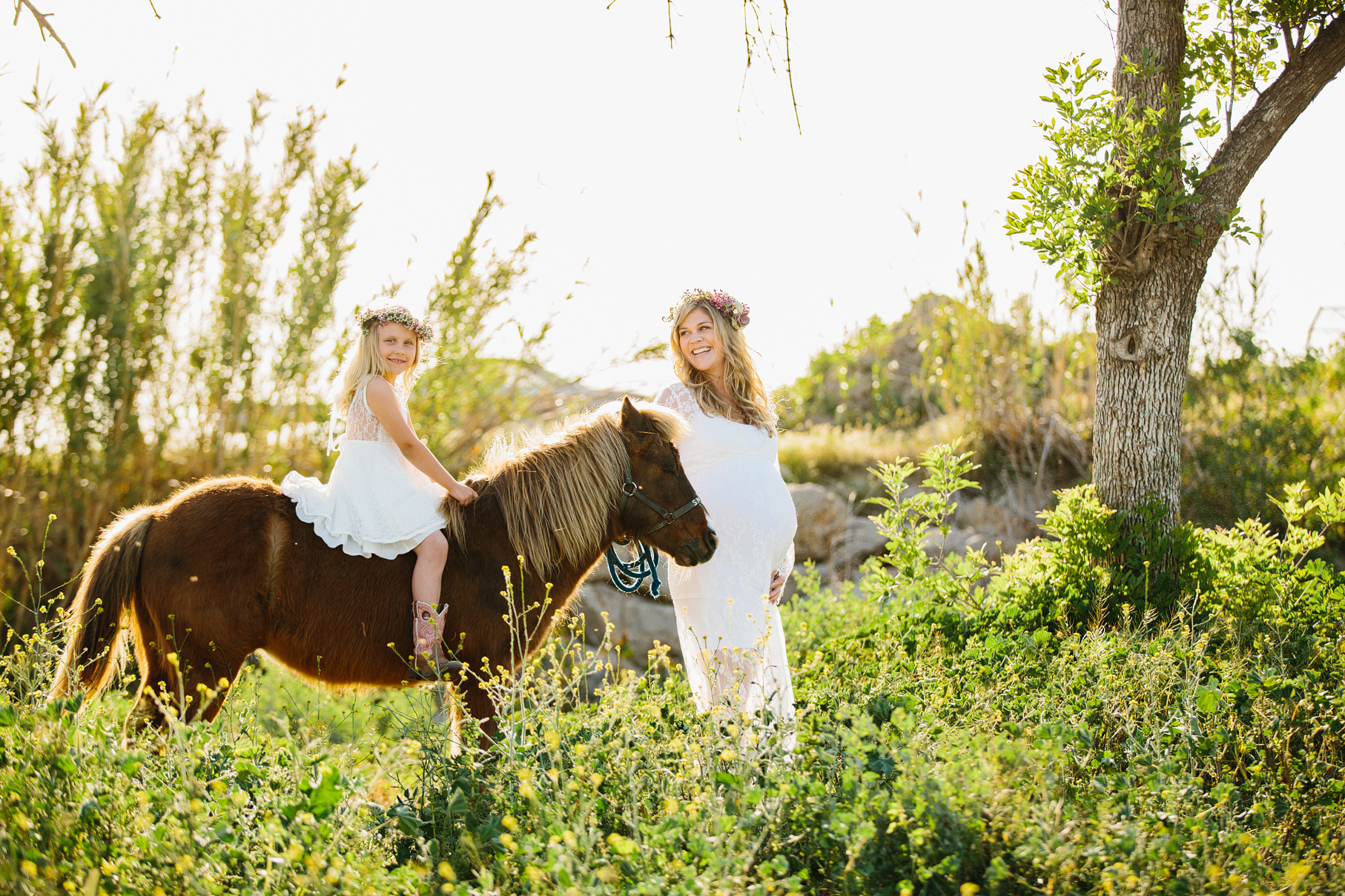 A maternity photography session in california with mother daughter their horse and a creek