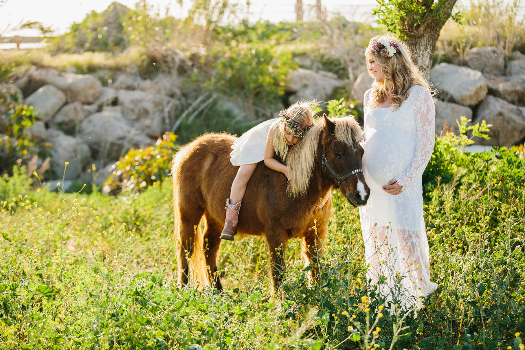 A maternity photography session in california with mother daughter their horse and a creek