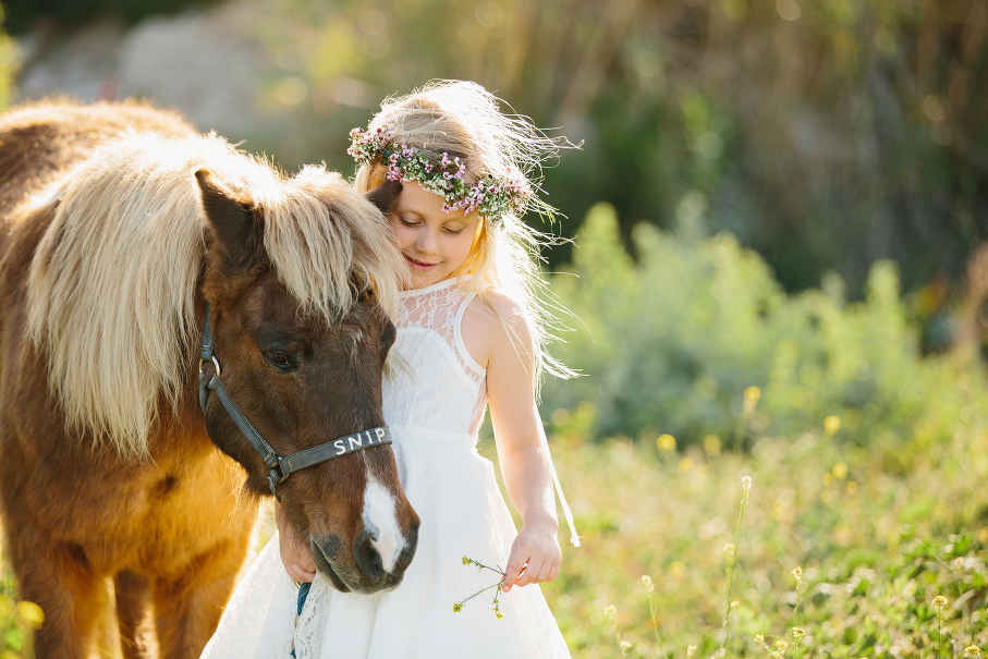 A maternity photography session in california with mother daughter their horse and a creek